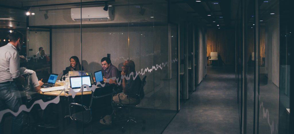 A team having a meeting inside a small conference room.