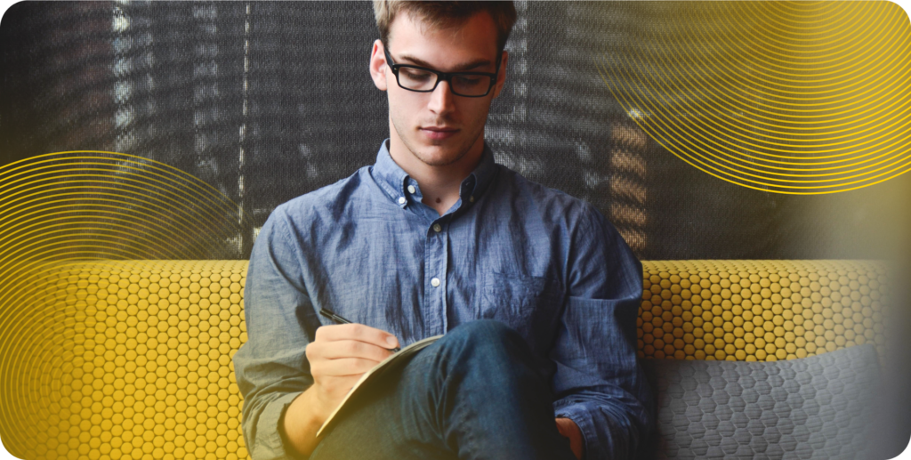 DevOps leaders sits on a yellow couch.